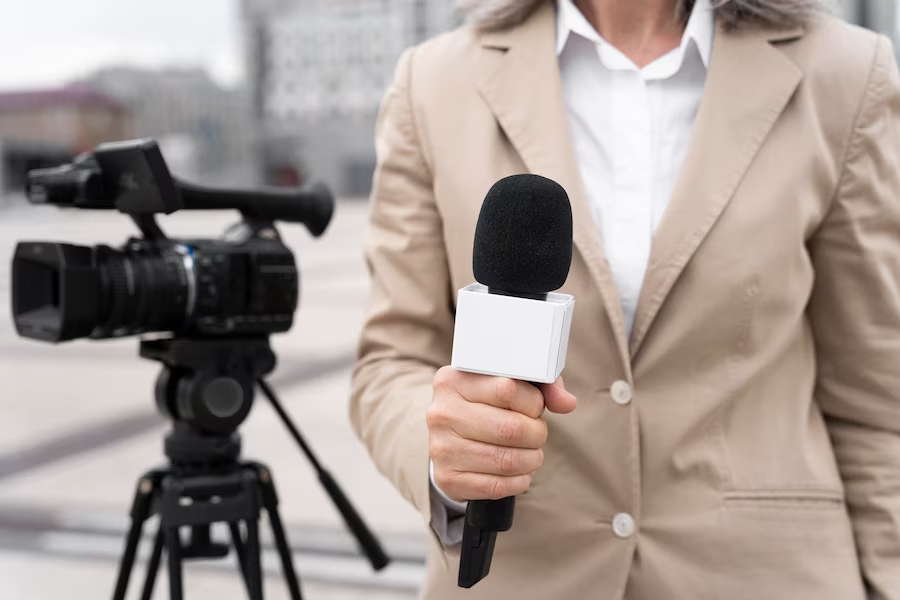 Camera and news reporter with microphone photo