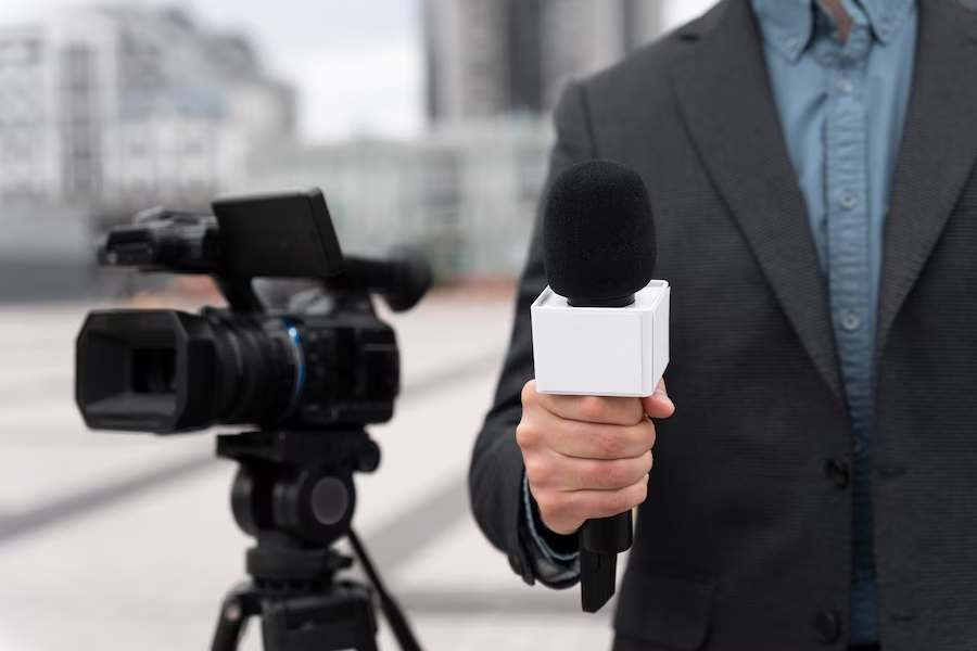 Camera and news reporter with microphone photo