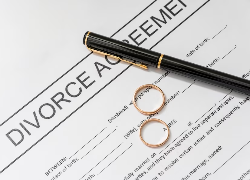 Picture of a divorce agreement with gold rings