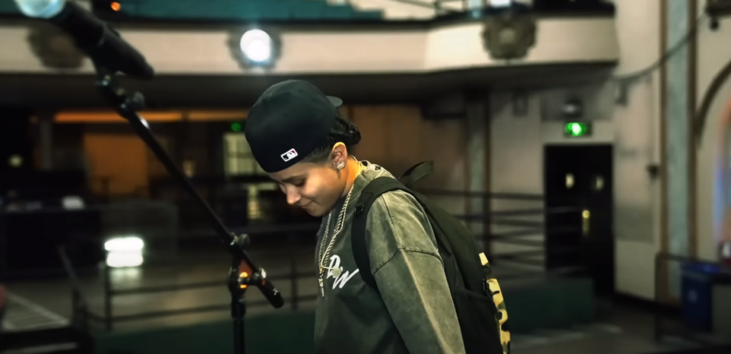 Yahritza Martinez in side view wearing a cap inside a studio