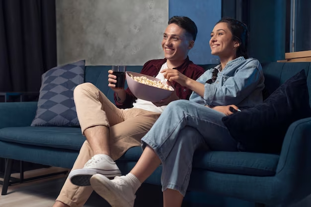 A man and a girl eating popcorn
