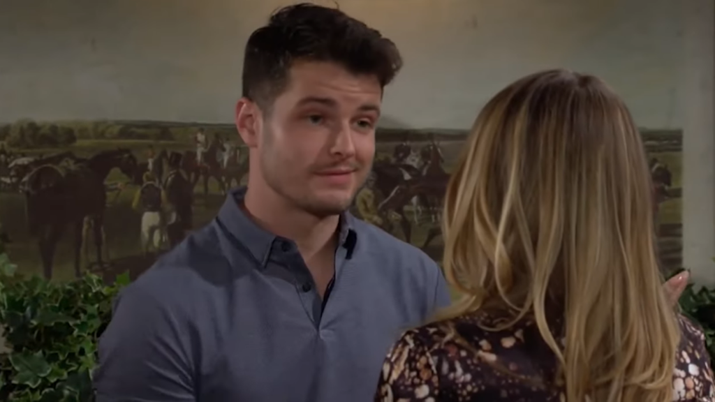 Michael Mealor in a blue shirt standing in front of the woman and smiling