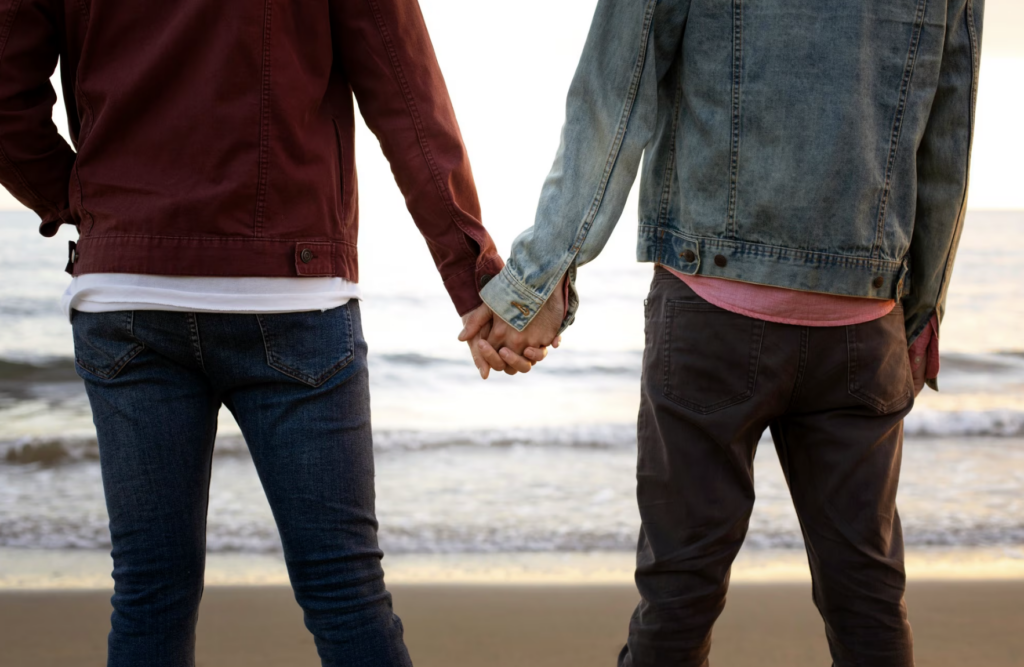 A gay couple spending time together on the beach.